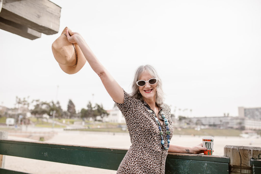 middle aged woman happily smiling and posing for a photo